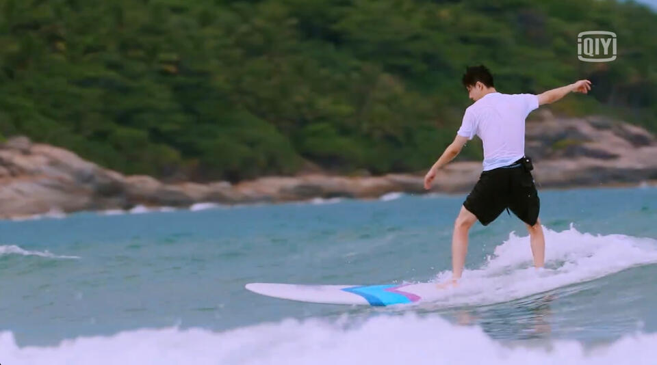 Wang Yibo surfing in ocean